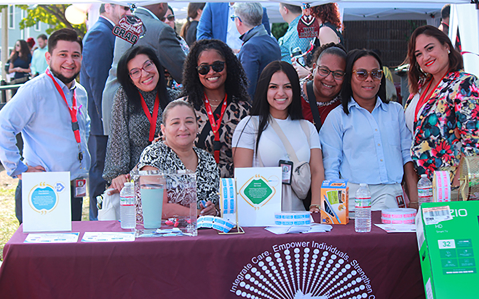 Group photo at booth promoting Awards for Advancing Minority Mental Health