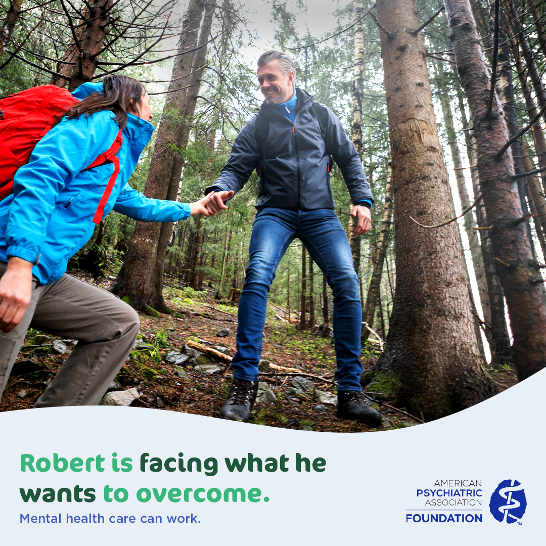 Man helps a woman while hiking in a forest. Text reads: ‘Robert is facing what he wants to overcome. Mental health care can work