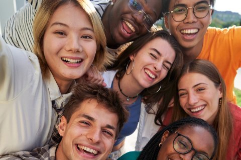 group of diverse youth posing for a selfie