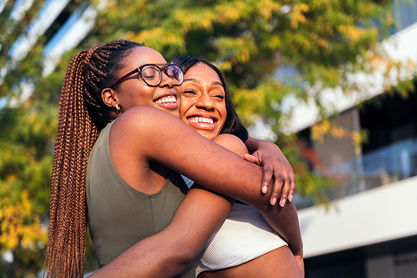 Two women hugging each other